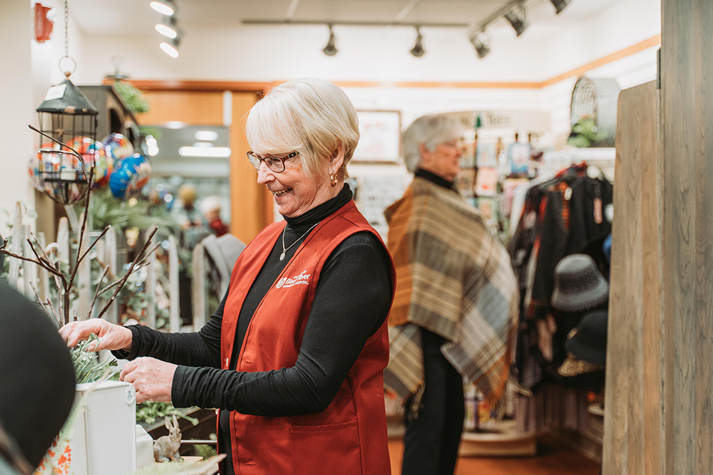 Volunteer working at the gift shop