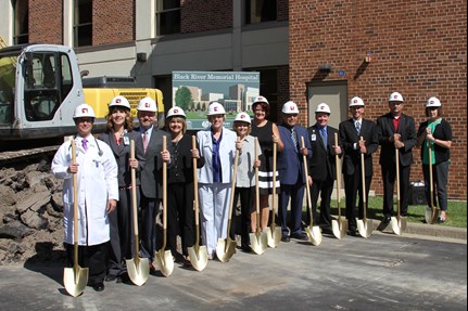 a group of Black River Memorial Hospital employees stand with shovels and hard hats