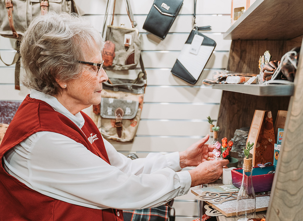 Partners volunteer working in the Gifts of Gratitude shop